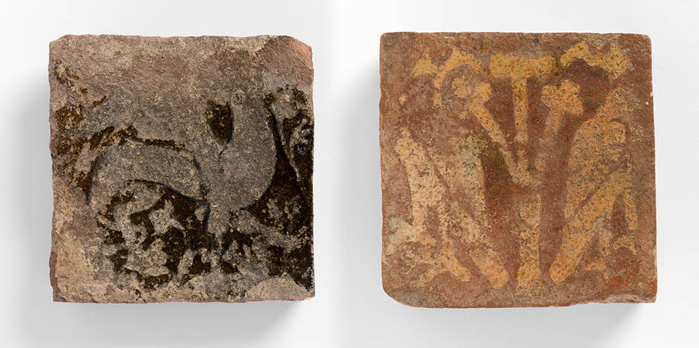Two Medieval tiles from Butley Priory. Left: A Griffin with Scattered Flowers. Right:Two Eagles either side of a Tree. Photo: FXP Photography, by permission of Orford Museum.