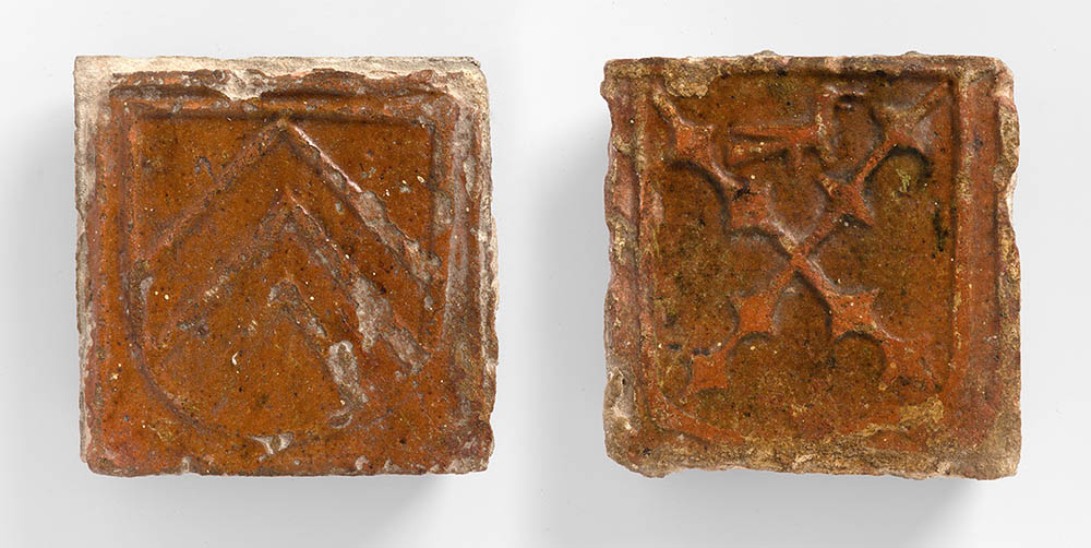 Medieval floor tiles from Butley Priory showing patrons coats of arms on shields.