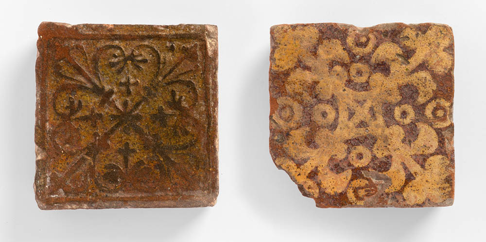 Two Medieval tiles from Butley Priory. Left: Cruciform Acanthus design. Right:Fleur-de-lis in Saltire with rings and dots. Photo: FXP Photography, by permission of Orford Museum.