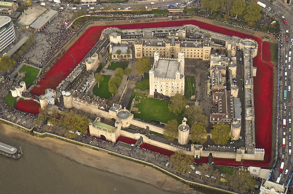 View of the Tower of London taken from a helicopter over the Thames on the morning of 11th November 2014. The moat of the Tower is filled with 888,246 ceramic poppies which give the impression that it is filled with blood