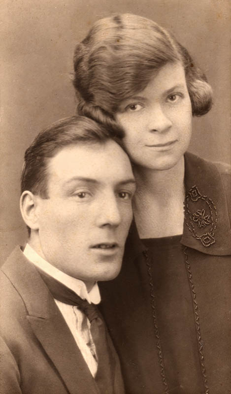 William and Daisy's engagement photograph. William is sitting and Daisy appears to be standing, the side of her chin touching his forehead