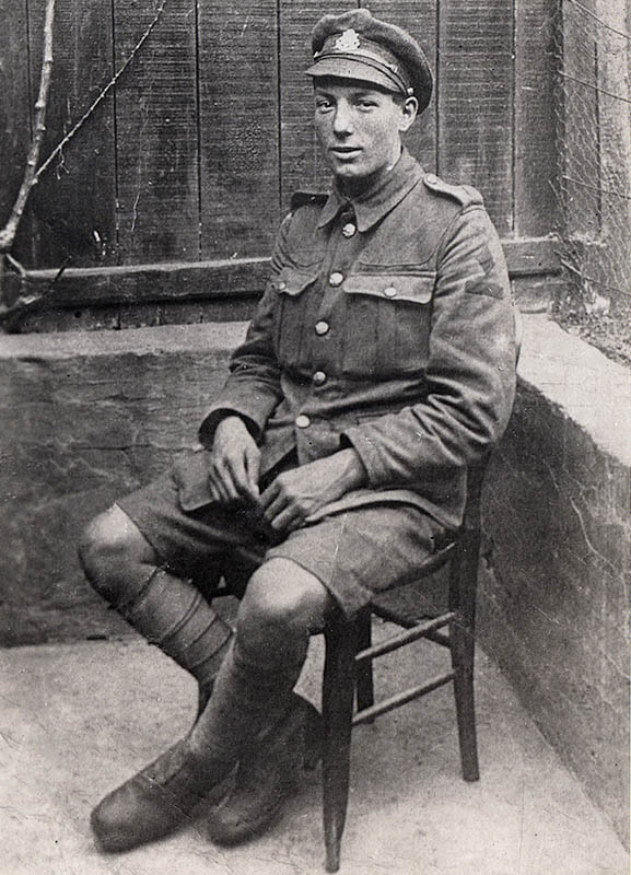 William Pearson sitting in a chair, wearing army uniform with shorts